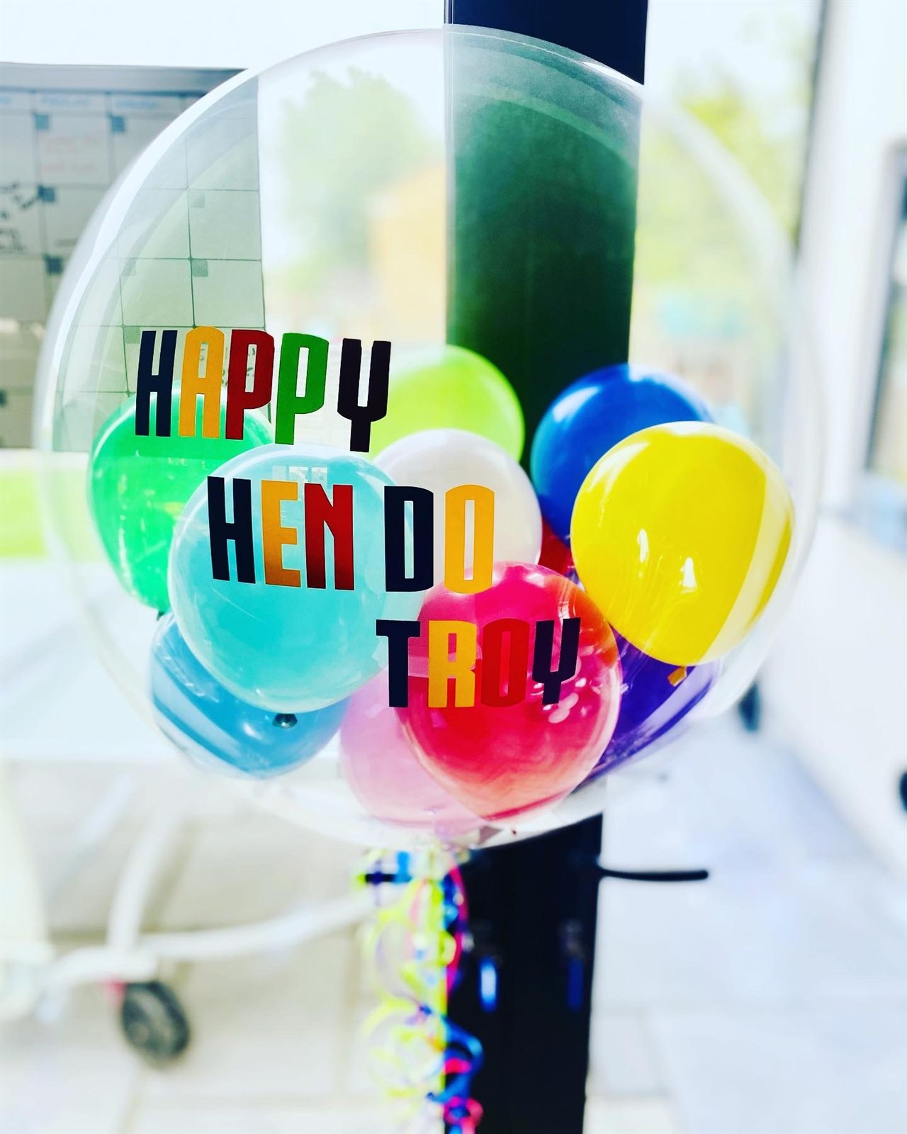 Personalised hen do bubble balloon with rainbow balloons inside