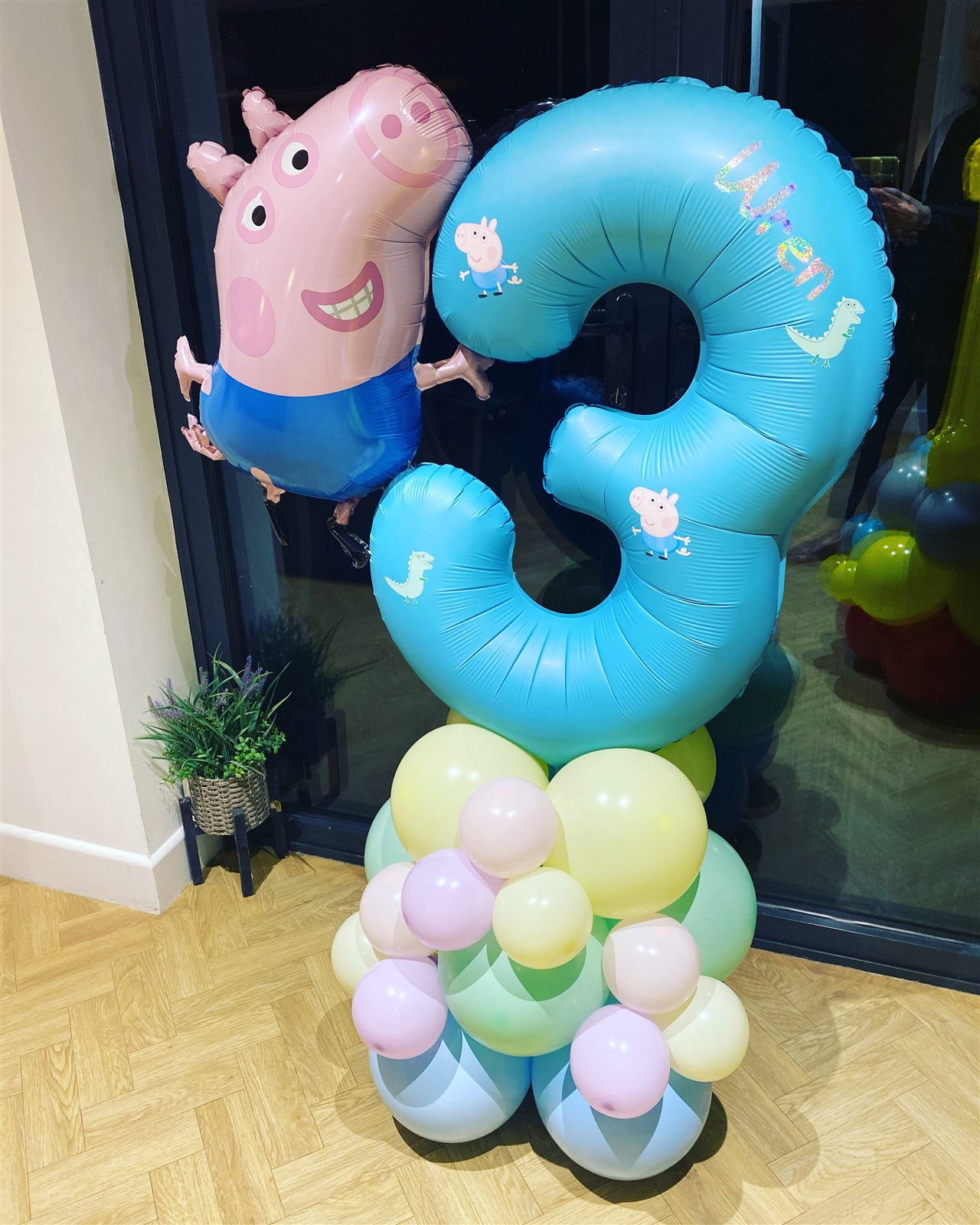 Pastel number 3 balloon stack with cartoon character