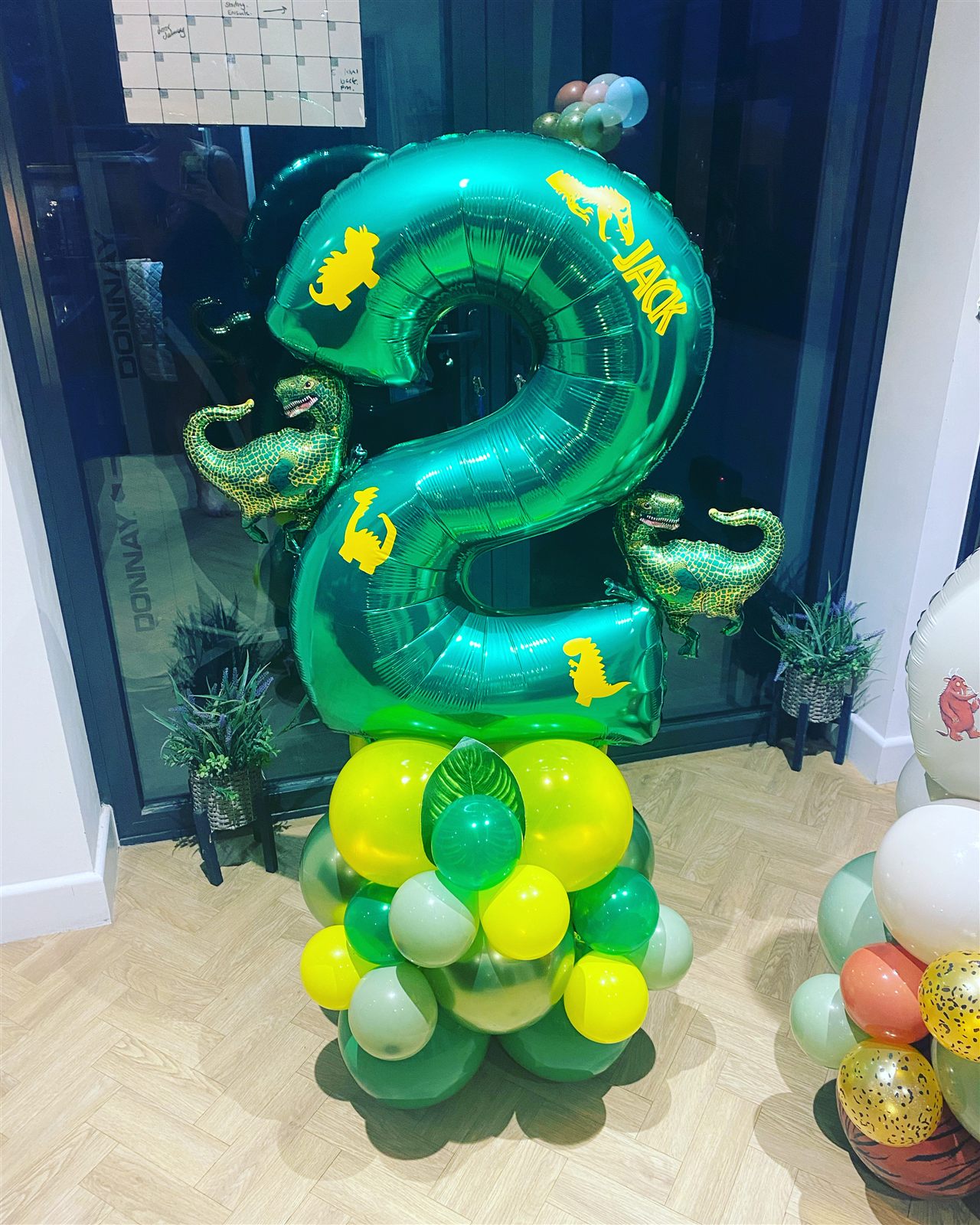 Dinosaur themed green number 2 balloon stack