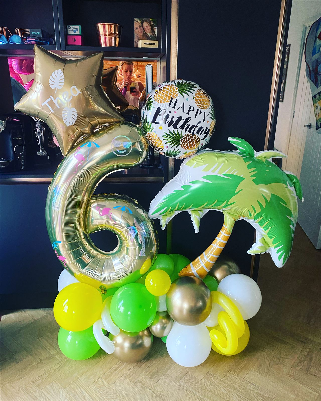 Tropical themed gold number 6 balloon stack with palm tree