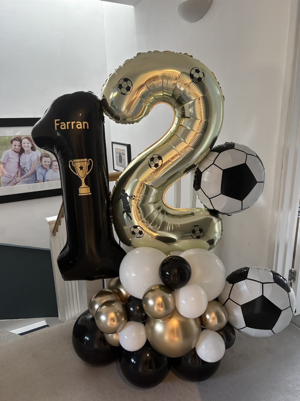 Football themed black and gold number 12 balloon stack