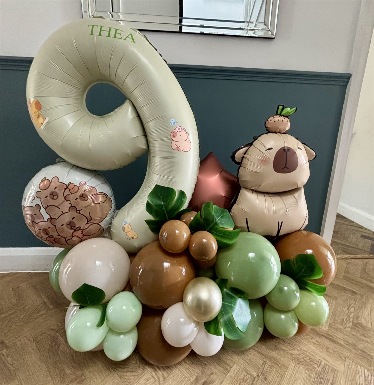 Sage green capybara themed number 9 balloon stack